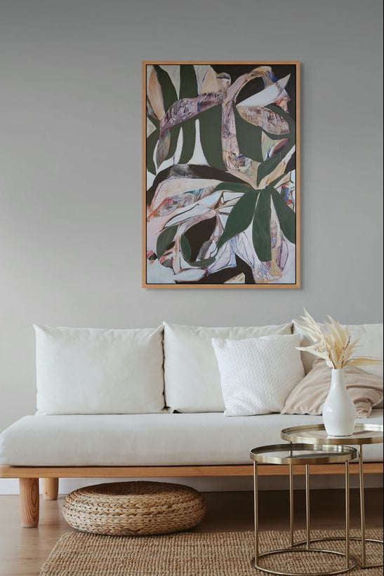 Living room with a beige sofa, abstract art, and decorative items.
