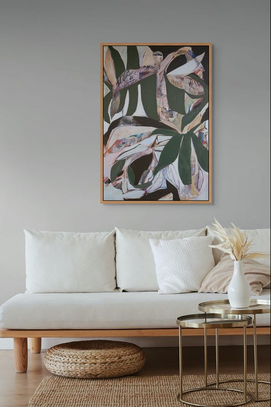 Living room with a beige sofa, abstract art, and decorative items.